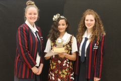 Eden with her trophy between Event organisers Erica and Ruth