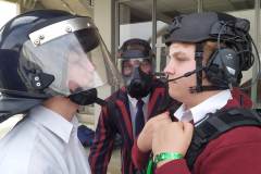 Cam, Richard and Joel try out various police helmets.