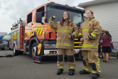 Caragh and Petra try on protective fire gear.